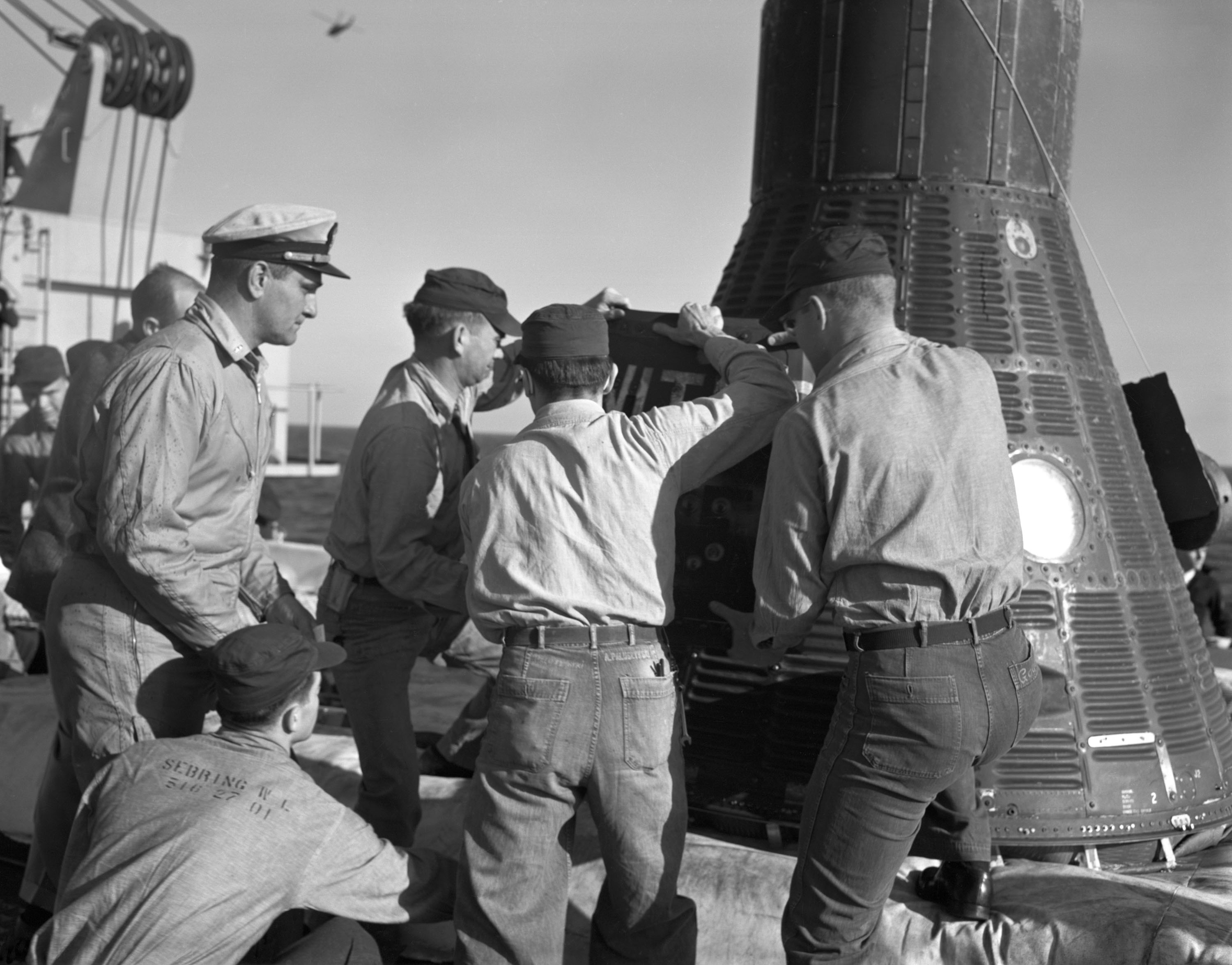 Recovery personnel aboard the USS Donner remove Ham, a 37-pound chimpanzee, from the Mercury-Redstone 2 spacecraft