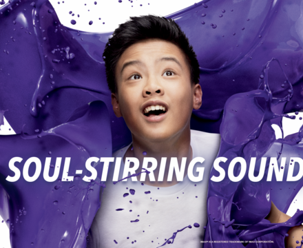 Image of purple paint splashed around a boy with the words "soul-stirring sound" on the photo