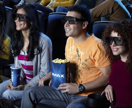 young adults at IMAX theater wearing 3D glasses