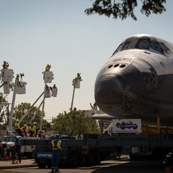 Endeavour on a Los Angeles street, with workers in lifts to get a better look at the scene