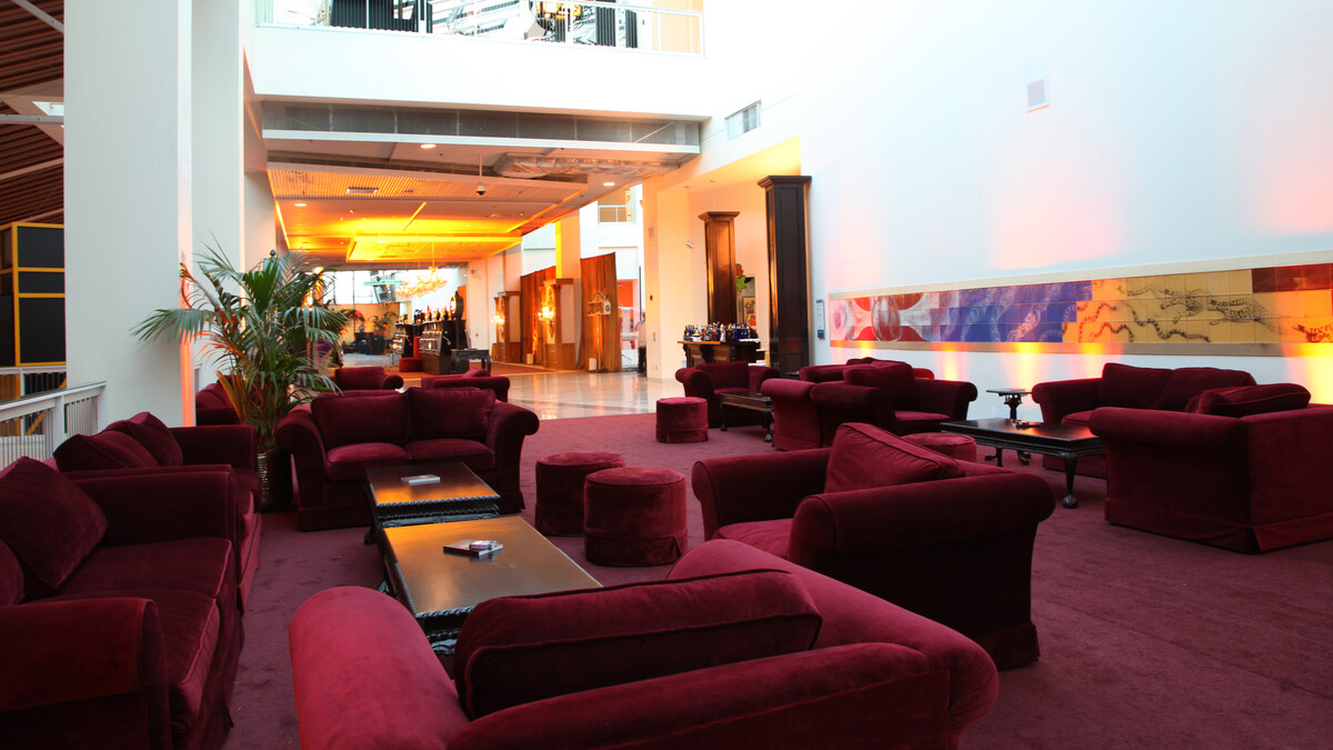Plush Maroon lounge furniture on maroon carpeting in Disney Court