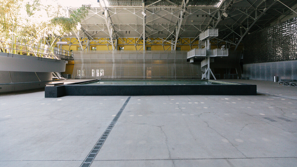 Empty view of the Wallis Annenberg Building Big Lab fountain - a large rectangular pool of water - turned off. 
