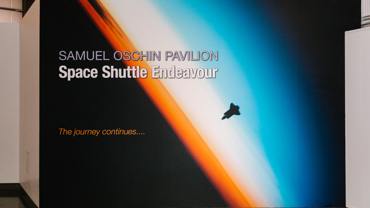 Samuel Oschin Pavilion entrance sign which reads 'Samuel Oschin Pavilion Space Shuttle Endeavour' 'The journey continues..' and features a photo of Endeavour from space