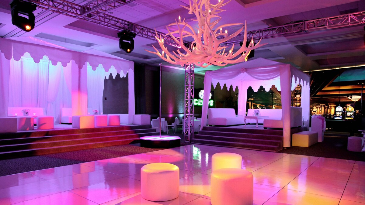 Loker Conference Center turned into gala afterparty featuring white dancefloor, white tented cabanas and dramatic antler chandelier