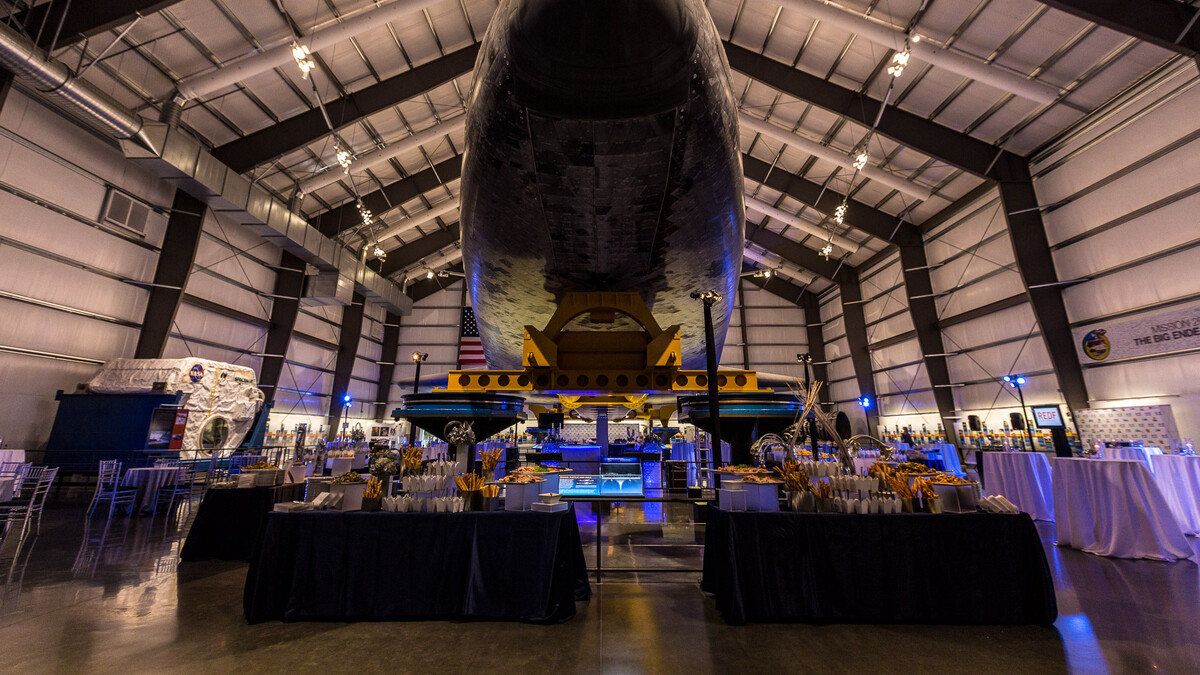 Private event catering buffet tables under the nose of the Space Shuttle Endeavour