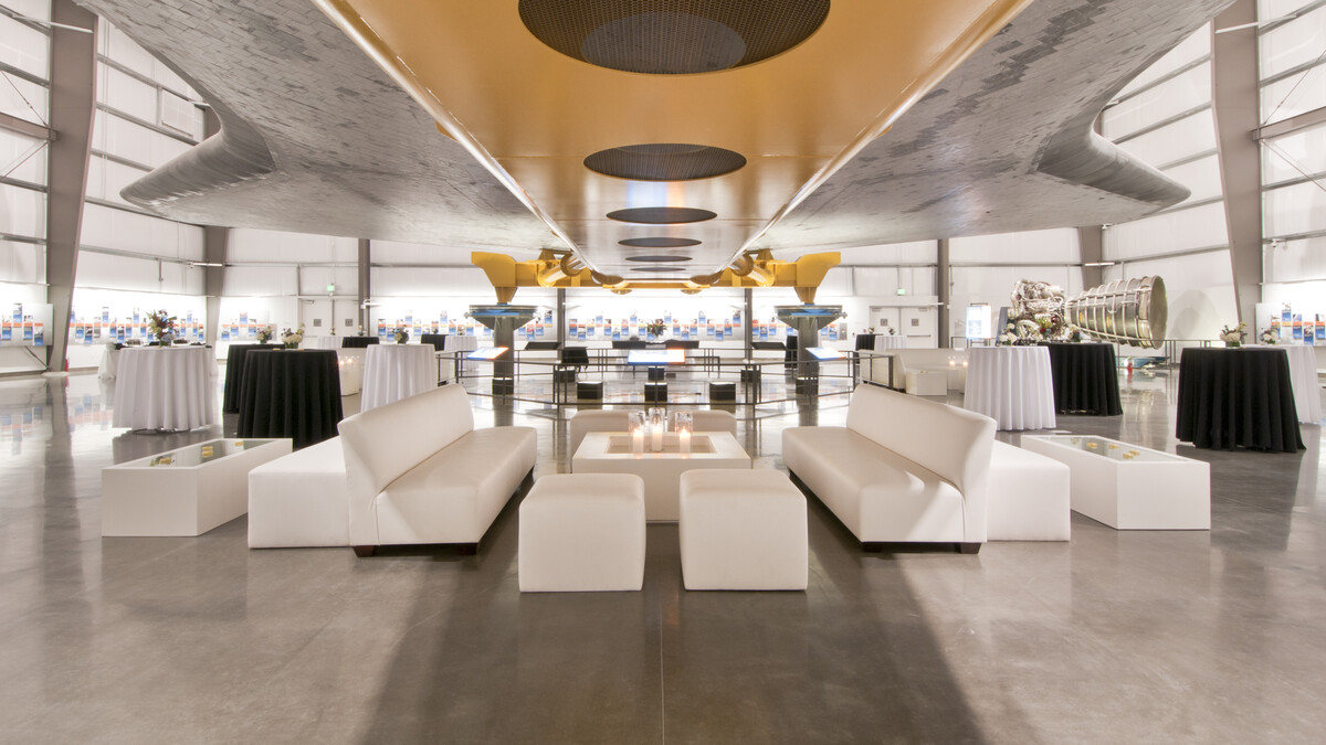 White event lounge furniture under the belly of the Space Shuttle Endeavour