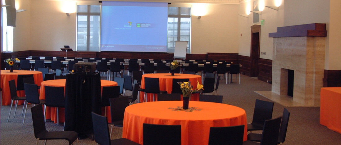 Erteszek Family Foundation Muses Room set with banquet rounds with orange linens